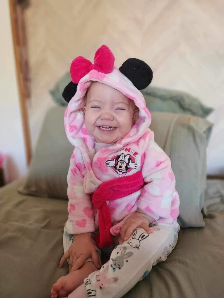 Bonnie, who lives with an STXBP1 disorder, smiling.