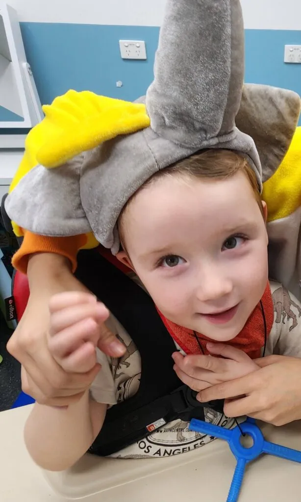 Caleb, who lives with an STXBP1 disorder, smiling.