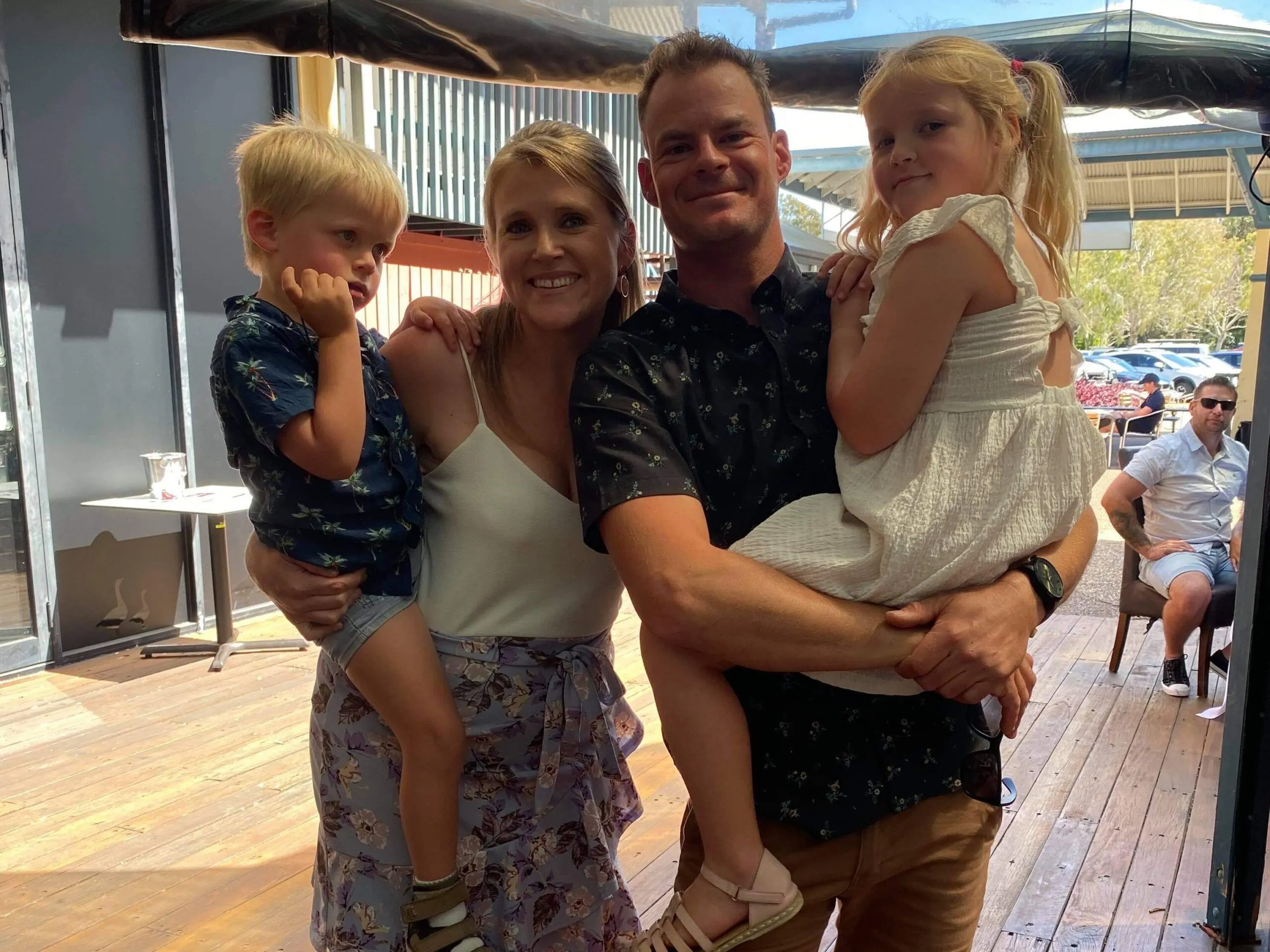 A family affected by an STXBP1 disorder, smiling together.