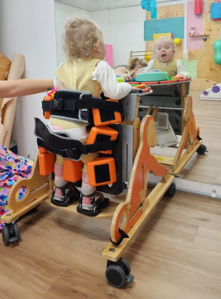 A child living with an STXBP1 disorder, supported by their family.
