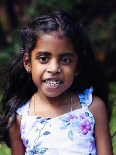 Tara, who lives with an STXBP1 disorder, smiling.